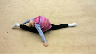 Little Asian gymnast performs well exercises