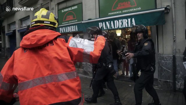 Riot police fire rubber bullets at demonstrators in Barcelona