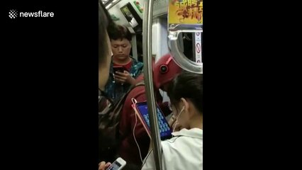 Man breaks out into song on Beijing subway
