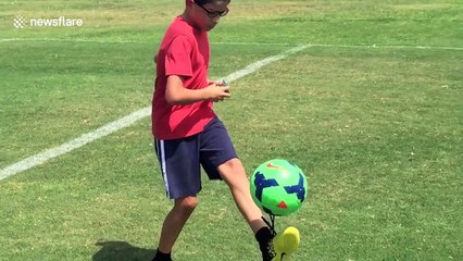 Boy solves Rubik's Cube while juggling soccer ball