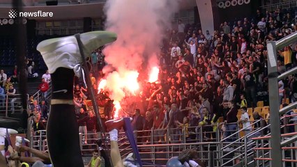 Greek basketball fans light flares at indoor team practice