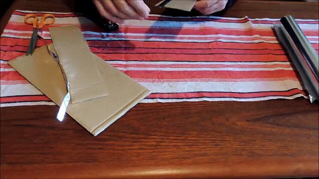 Home made slot car track of cardboard, aluminum foil and staples