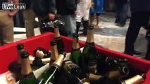 The New York Yankees celebrate victory in the wild card game with champagne in Yankee Stadium locker room.