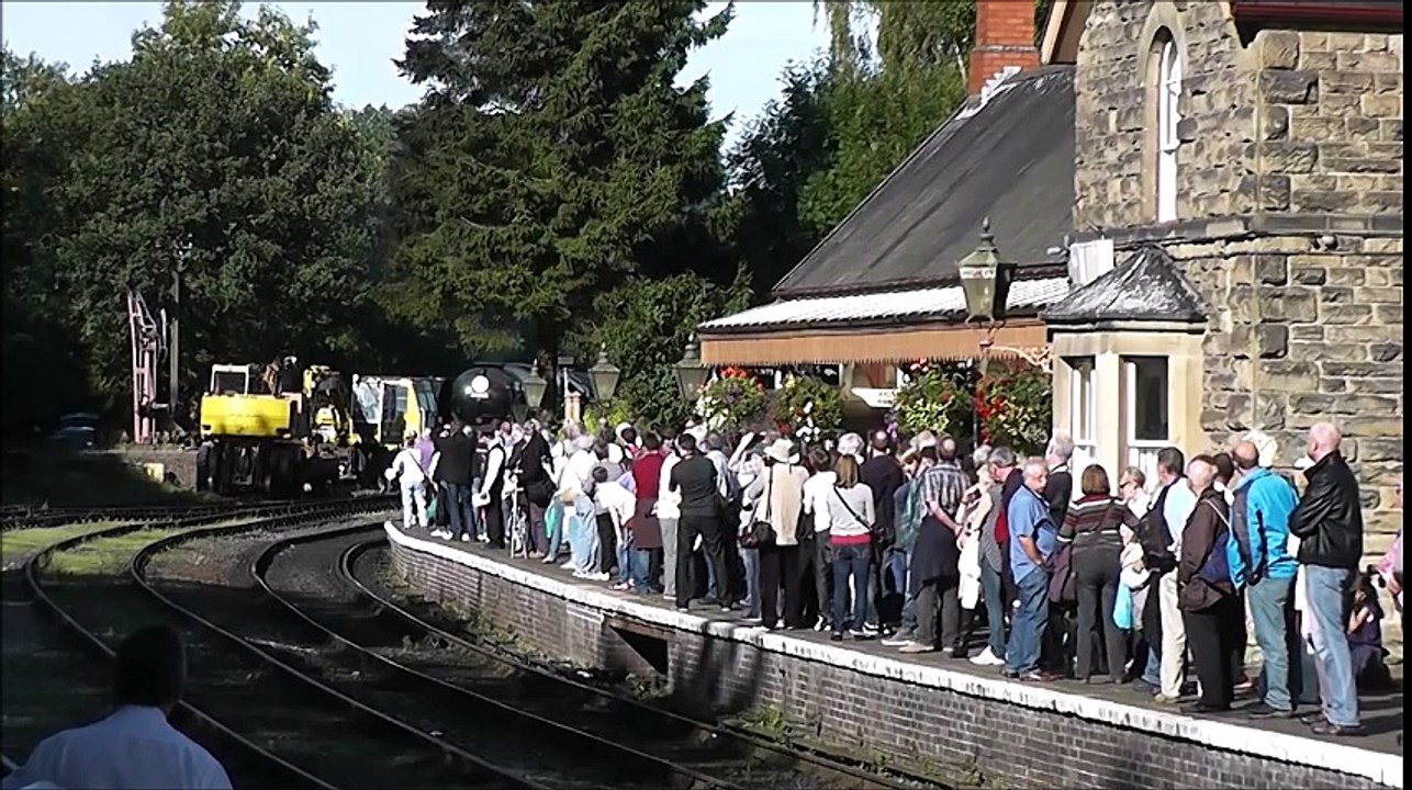 Incoming Steam Engine stops in front of Train Station Platform