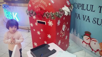 Baby Mizn writing her wishes for Santa Claus