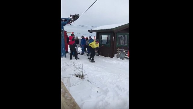 Des snowboardeurs débutants prennent le tire-fesses