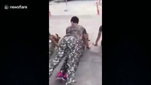 Male students perform push-ups over female classmates
