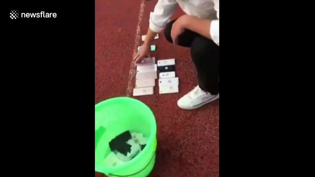 Teacher at Chinese school smashes students' mobile phones