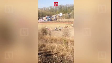 Spectator tries to cross a motocross track....