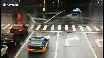 Driver throws umbrella to very wet on-duty policeman