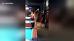 Naked woman in bar chases customer around pool table with cue