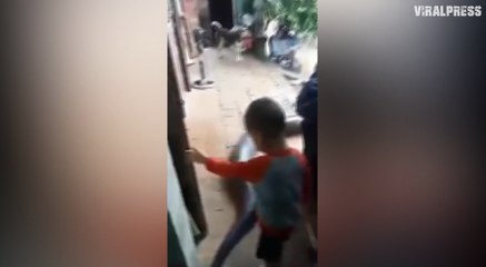 Three-year-old boy riding PYTHON during floods in Vietnam