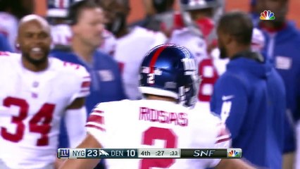 Eli Manning coaches up new receivers during pre-game warm-ups in Denver