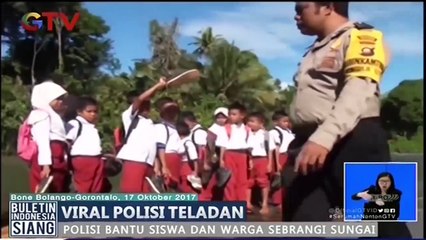 Salut! Polisi Ini Selalu Bantu Para Pelajar untuk Menyebrangi Sungai Deras