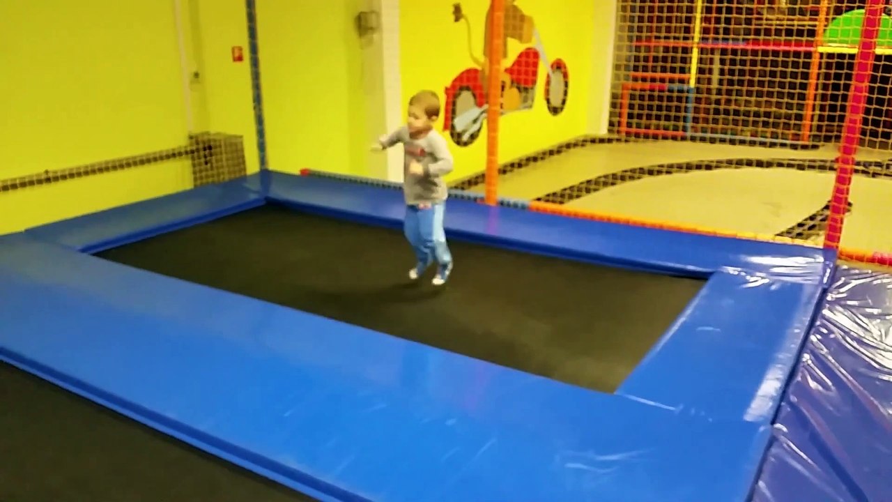 Funny Indoor playground. Kids jumping on trampoline
