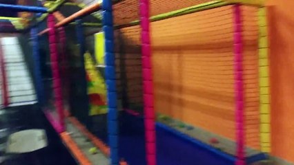 Kids playing with balls and slide on rainbow slider