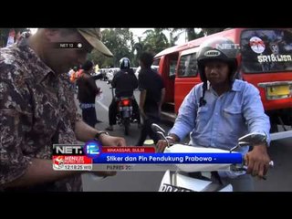 NET12 Warga Turun ke Jalan Dukung Prabowo Hatta Bagikan Stiker dan PIN
