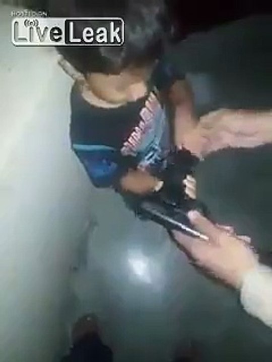 Dad helps his son load and shoot a pistol