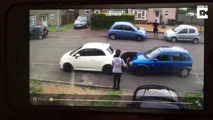 Man moves a badly parked car with his bare hands