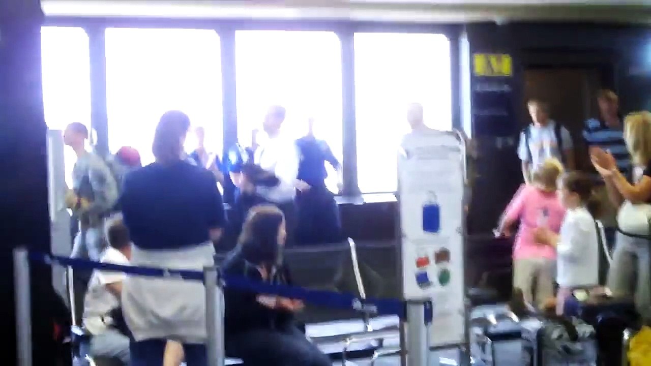 Crowd Cheers as Families Welcome Home Soldiers at Airport