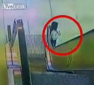 Woman's shirt gets trapped in an escalator's belt, gets dragged up