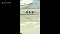 Flight attendant falls out of cabin pre-flight