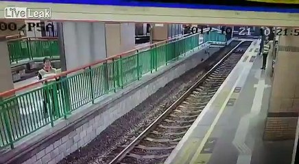 Shocking moment when man pushes woman onto train tracks