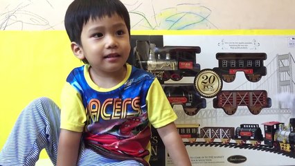 Kid playing with CLASSICS TRAIN Toy from SmokeScreen - Real Smoke, Lights and Train Sounds-BE-aXXX6eIs