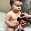 Sweet baby boy rests head on nurse's hand