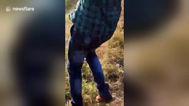 Villagers in trouble for torturing baby crocodile, posing for selfies