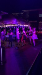 The guys are drinking while the ladies continue to dance!