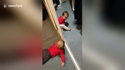 Adorable baby twins discover peek-a-boo