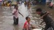 Children Play on Flooded Street as Heavy Rain Prompts School Closures in India