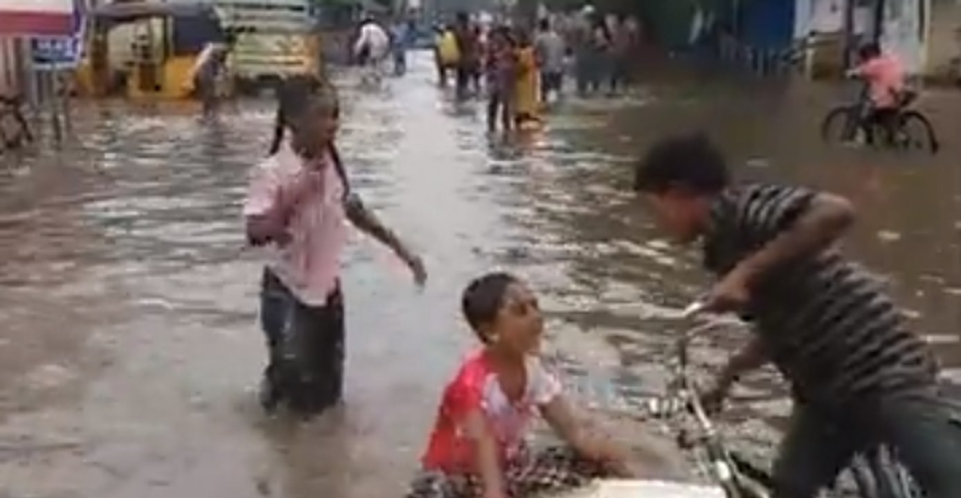 Children Play on Flooded Street as Heavy Rain Prompts School Closures in India