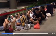 People Stare at Phones as They Camp Out Overnight for iPhone X