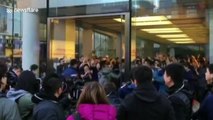 Apple employees cheer to welcome customers waiting for iPhone X in Beijing