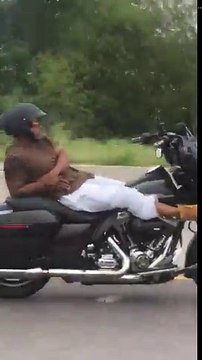 Guy rides motorcycle with no hands on freeway will leaning all the way back and then cuts across all lanes of traffic (with no hands)