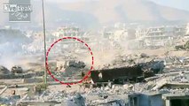 Syrian rebels lob a shell onto an armoured regime bulldozer on the Jobar front