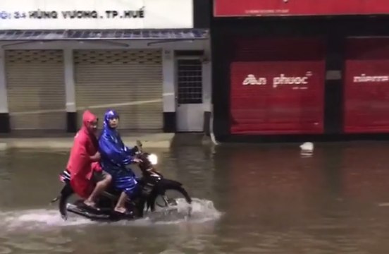 Motorbikes Speed Through Hue's Flooded Streets