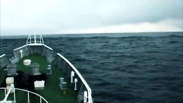 Japan, Tsunami. Coast Guard ship rides over the tsunami waves. 日本 - 津波