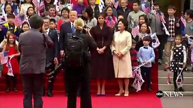 Pres. Donald J. Trump, first lady Melania Trump greeted by children waving U.S. and South Korean flags
