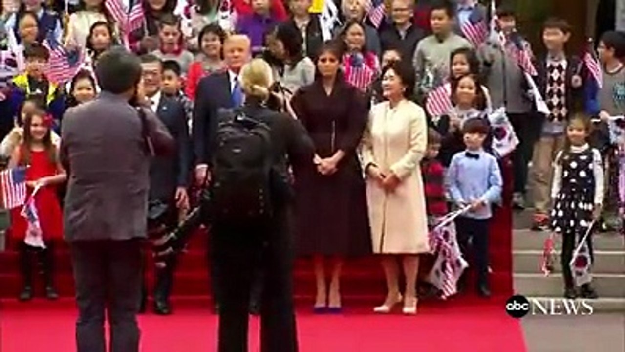 Pres. Donald J. Trump, first lady Melania Trump greeted by children waving U.S. and South Korean flags
