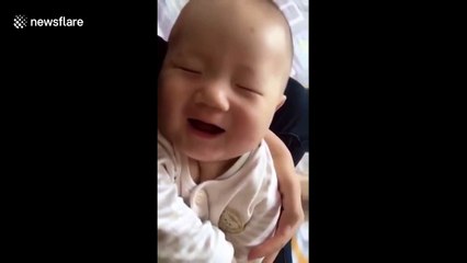 Dreaming baby laughs in his sleep
