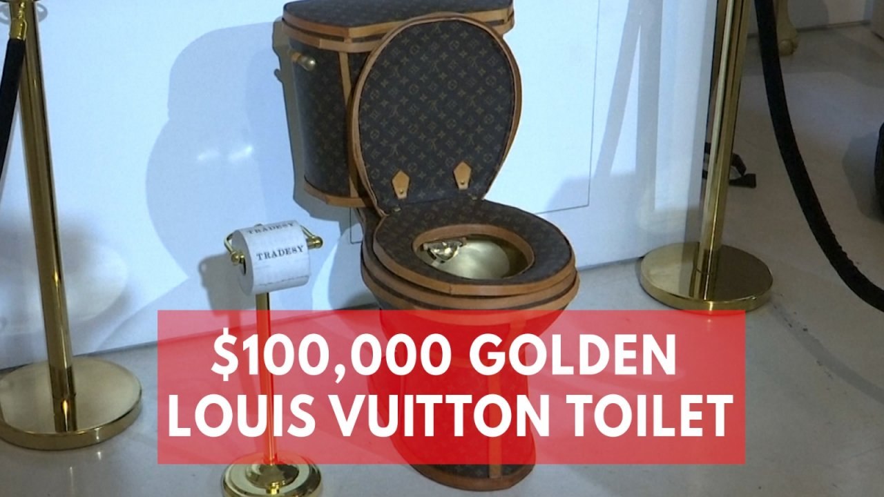 Golden toilet covered in luxury Louis Vuitton m...