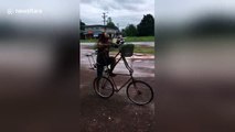 Cyclist avoids floods with his double-decker bike