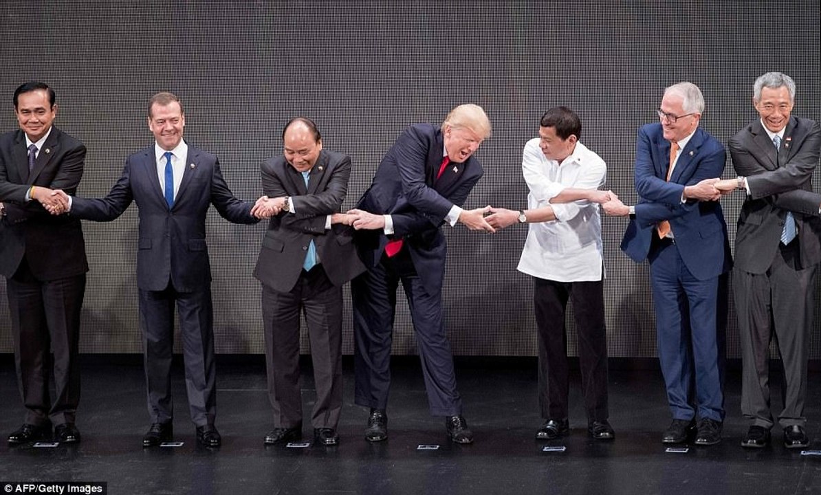 Trump broke into an uneasy smile after mastering the confusing cross-ways handshake