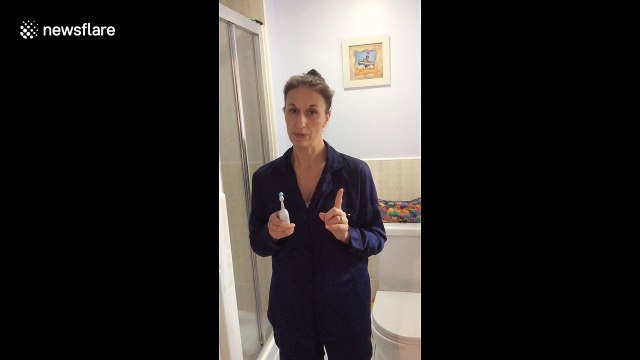 Busy mum exercises while she brushes her teeth