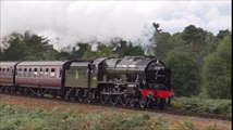 Steam Engine with a Large Train Puffing along the British Countryside