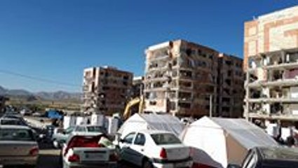 People Look Through Remains of Apartment Blocks to Salvage Items After Earthquake