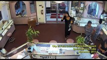 Woman sneaks in the back room to steal jewelry in an open safe